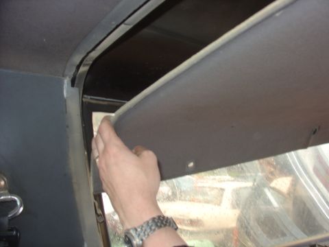 1988 Ford Bronco - Interior view of a vehicle's headliner and sun visor being adjusted.