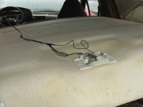 1988 Ford Bronco - The headliner of a vehicle shows exposed wiring and a disassembled light fixture, with the dashboard visible in the background.
