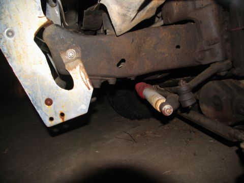 1978 Ford Bronco - Undercarriage view shows a rusty frame and suspension parts, including a shock absorber.