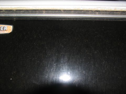 1978 Ford Bronco - A close-up view of a black panel with a partial badge is visible.