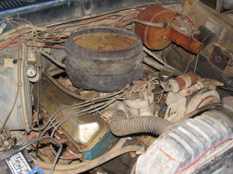 1978 Ford Bronco - Engine bay details, including air cleaner and various rusty engine parts, suggesting a vehicle in need of restoration.