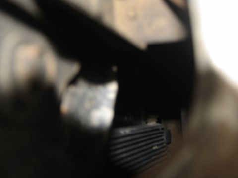 1978 Ford Bronco - Detail of a ribbed part within a vehicle's engine compartment.
