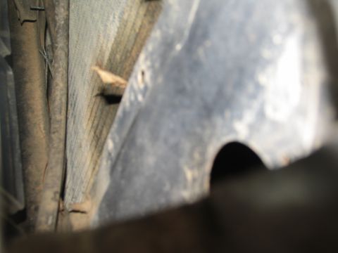 1978 Ford Bronco - A close-up view of the underside of a vehicle, revealing its mechanical components and frame.