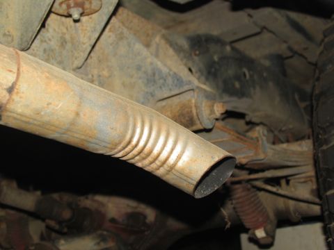 1978 Ford Bronco - Underside view of vehicle's exhaust pipe and suspension system.