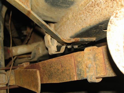 1978 Ford Bronco - Undercarriage view shows significant rust on leaf spring and frame components.