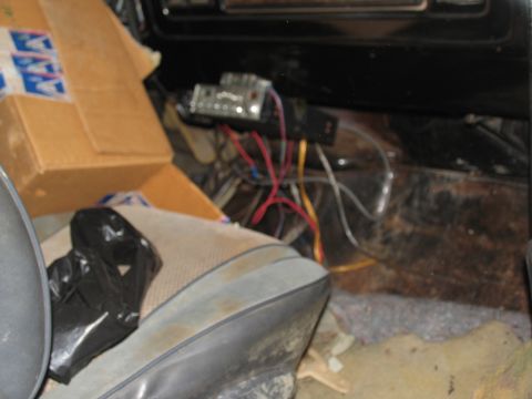 1978 Ford Bronco - Interior view of a vehicle with a seat, box, and electrical wiring visible.