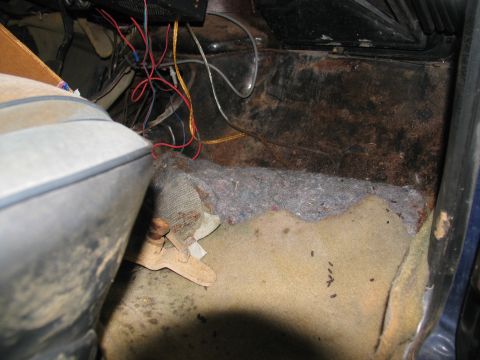 1978 Ford Bronco - The interior floor shows exposed wiring and damaged carpeting, suggesting a need for restoration.