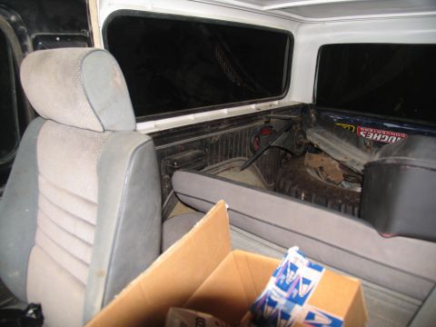 1978 Ford Bronco - Interior view of a vehicle's cabin and cargo area, with a box of items in the foreground.