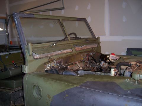 1974 Land Rover Land Rover - A Land Rover Series II/III in a garage, undergoing restoration with its hood open.