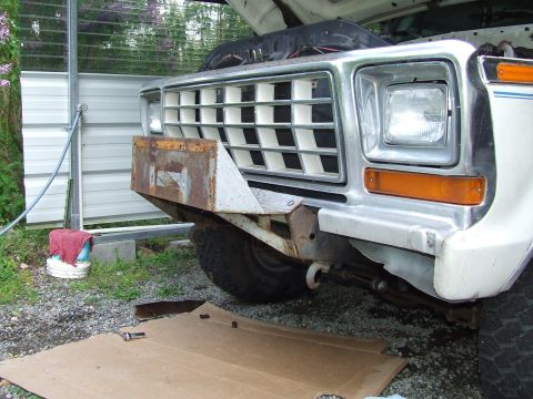 1979 Ford Bronco - The front of a truck is shown with a custom winch bumper installed over the original grille.
