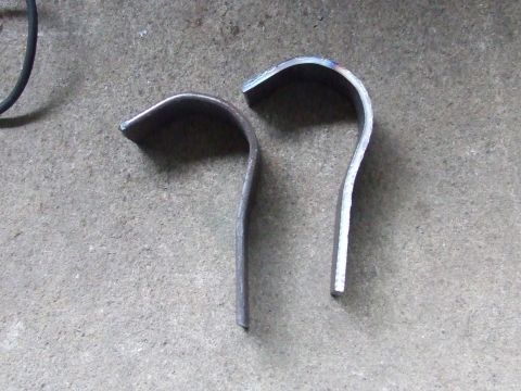 1979 Ford Bronco - Two bent metal pieces are shown on a concrete surface.