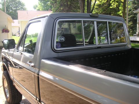1992 Ford F-250 - This two-tone 1992 Ford F-250 pickup truck is seen from the side, a CVN sticker on the rear window.