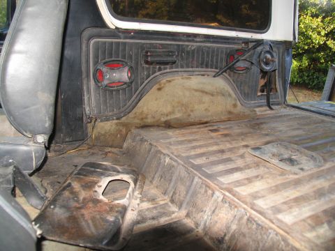 1978 Ford Bronco - The rear interior of a 1978 Ford Bronco, showing the cargo floor and seat.