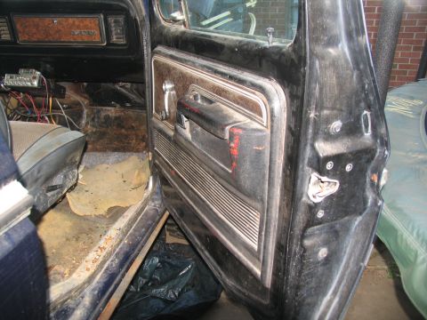 1978 Ford Bronco - Interior view of a 1978 Ford Bronco, focusing on the driver's side door panel and seat.