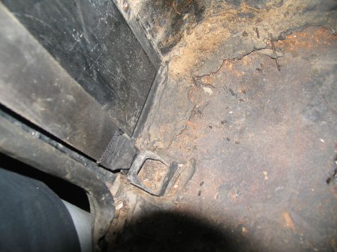 1978 Ford Bronco - The interior floor of the vehicle shows significant rust and debris, indicating a need for restoration.