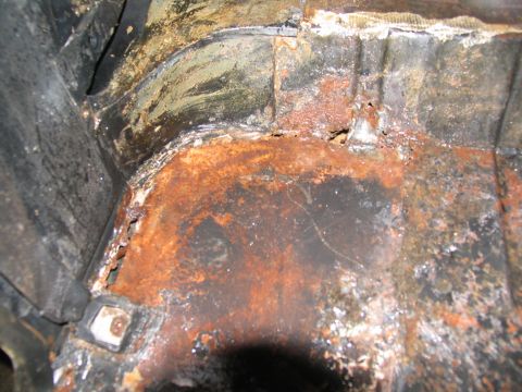 1978 Ford Bronco - The interior of the vehicle shows extensive rust and damage, indicating a poor condition.