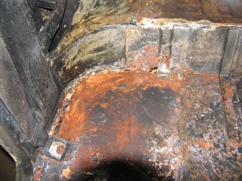 1978 Ford Bronco - The interior floor pan shows significant rust and corrosion, indicating potential structural compromise.