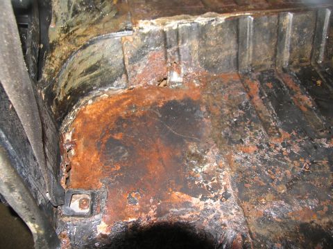 1978 Ford Bronco - Interior floor pan shows significant rust damage and wear.