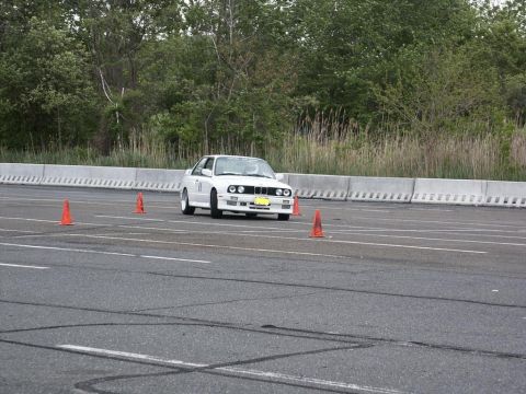 2001 Mercury Grand Marquis - A white BMW E30 M3 navigates an autocross course marked by orange cones.