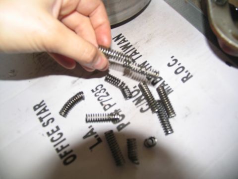 1978 Ford Bronco - Small metal springs are shown on paper with text indicating they are made in Taiwan.
