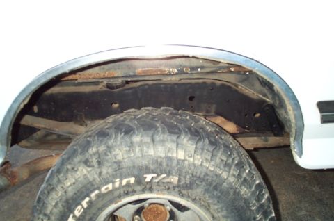 1988 Ford Bronco - Close-up view of the rear wheel well and suspension components on a 1988 Ford Bronco.
