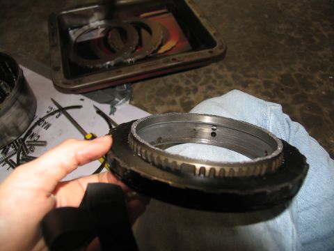 1978 Ford Bronco - Close-up of a transmission component with gears and other parts laid out on a workbench.