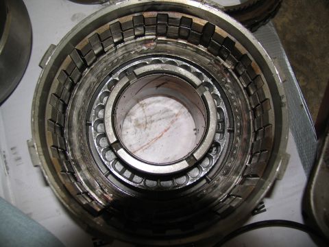 1978 Ford Bronco - A transmission clutch pack shows signs of wear and tear, with metal teeth and friction plates clearly visible.