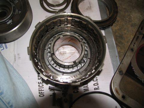 1978 Ford Bronco - A close-up view of a disassembled automatic transmission drum, showing clutch plates and springs, likely for a rebuild.