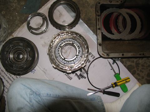 1978 Ford Bronco - Various components of an automatic transmission are spread out, ready for repair or reassembly.