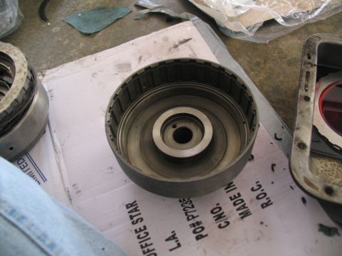 1978 Ford Bronco - A disassembled transmission part is shown, with some text visible on the paper beneath it.