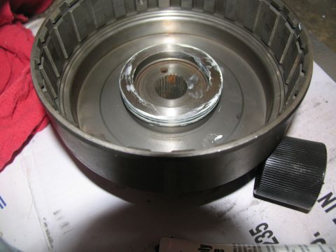 1978 Ford Bronco - A close-up view of a disassembled transmission component, showing internal parts and grease application.