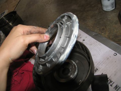 1978 Ford Bronco - A hand holds a metal transmission component, likely during a rebuild or repair process.
