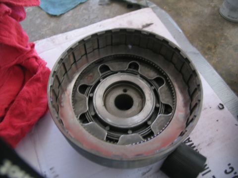 1978 Ford Bronco - A transmission clutch pack is shown, with a red cloth nearby.