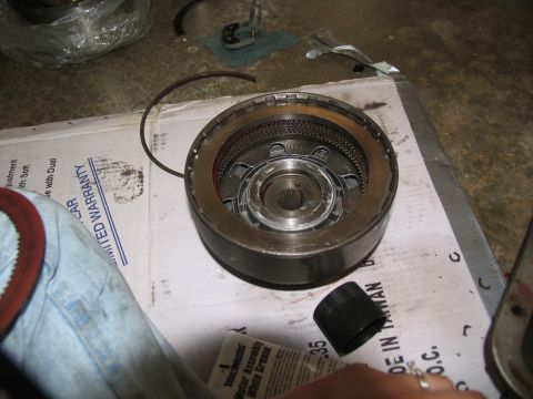 1978 Ford Bronco - A transmission clutch pack is disassembled on a cardboard box with limited warranty information.