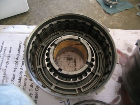 1978 Ford Bronco - A disassembled transmission drum sits on a surface with some text visible on paper underneath.