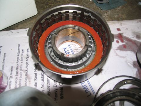 1978 Ford Bronco - A close-up view of a transmission drum, showing its internal components and some scattered red fluid.