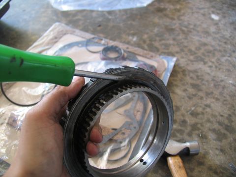 1978 Ford Bronco - A transmission part is being examined with a screwdriver, with a gasket kit visible in the background.
