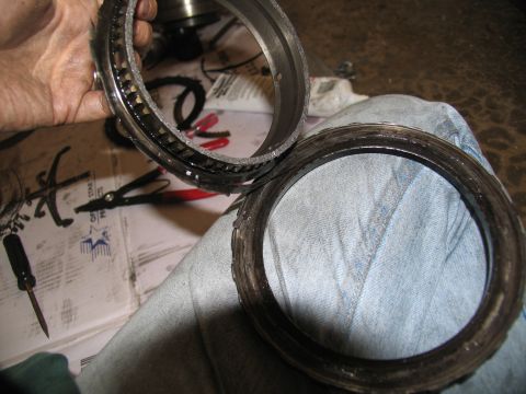 1978 Ford Bronco - Close-up of worn transmission clutch pack components being held for inspection.