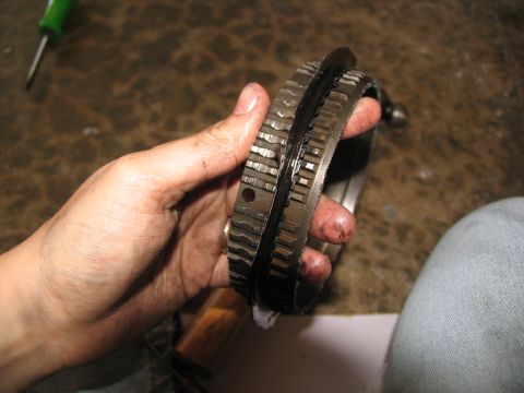 1978 Ford Bronco - Close-up of a worn transmission gear, showing significant damage to its teeth and structure.