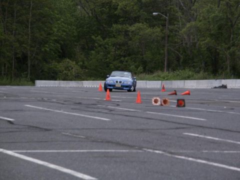2001 Mercury Grand Marquis - A blue convertible is parked on a paved lot with orange cones scattered around.