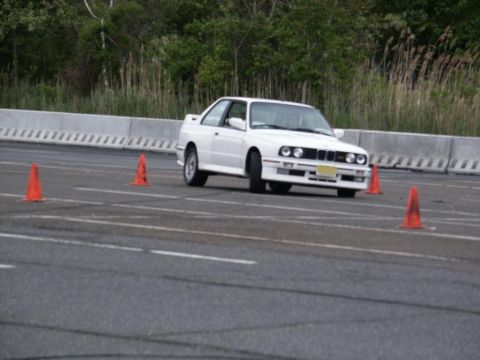 2001 Mercury Grand Marquis - A white BMW E30 M3 navigates an autocross course marked by orange cones.