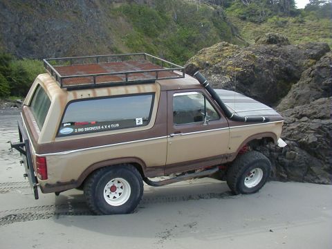 1994 Ford Explorer - This modified Ford Bronco, likely from the 1980s, is equipped for off-road adventures with a snorkel and roof rack.