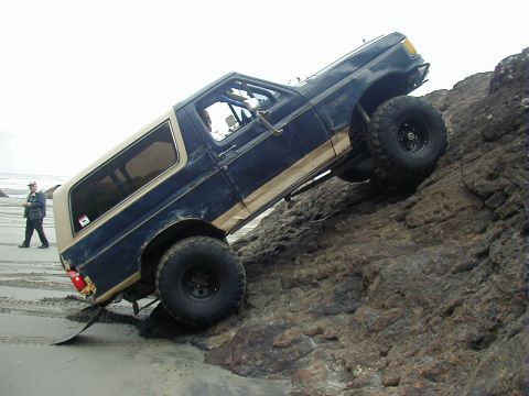 1994 Ford Explorer - This 1994 Ford Explorer is navigating a rocky incline on a sandy beach.