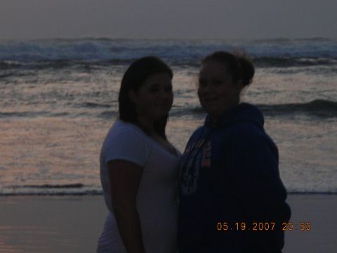 1994 Ford Explorer - Two women stand on a beach with waves in the background at dusk.