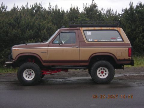 1994 Ford Explorer - This lifted SUV, possibly a Ford Bronco, is seen from the side with off-road tires and a roof rack. The date stamp indicates it was photogr…