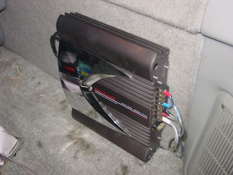 1997 Ford Ranger - A car stereo amplifier with visible wiring is placed on the floor of a vehicle's interior.