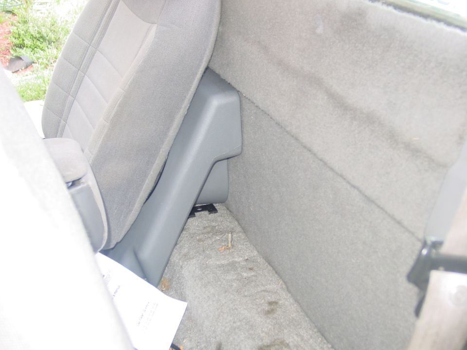 1997 Ford Ranger interior showing passenger seat and rear cab wall with a plastic trim piece