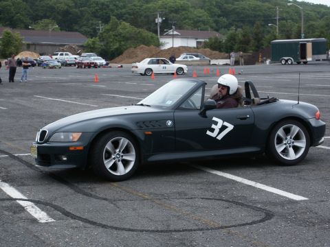 2001 Mercury Grand Marquis - A BMW Z3 convertible participates in an event, with other vehicles and cones visible in the background.