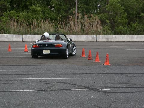 2001 Mercury Grand Marquis - A BMW Z3 convertible is driven through an autocross course with several orange cones marking the path.