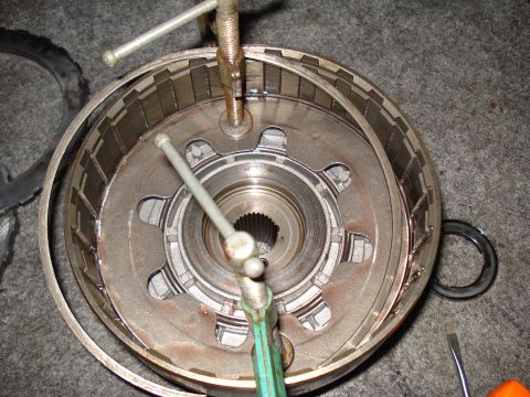 1984 Ford Bronco - Close-up of a transmission drum assembly with internal splines and clutch plates being worked on.